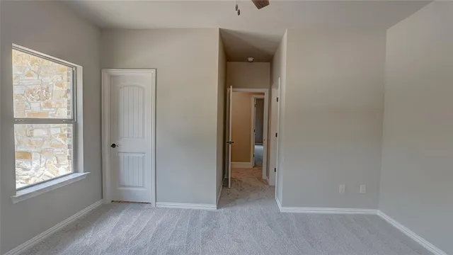 an empty room and chandelier fan