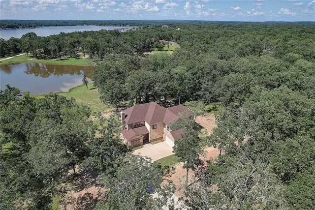 an aerial view of a house with a garden and a yard