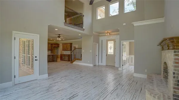 a view of a hallway with wooden floor and living room