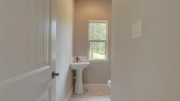 a bathroom with a sink a window and shower