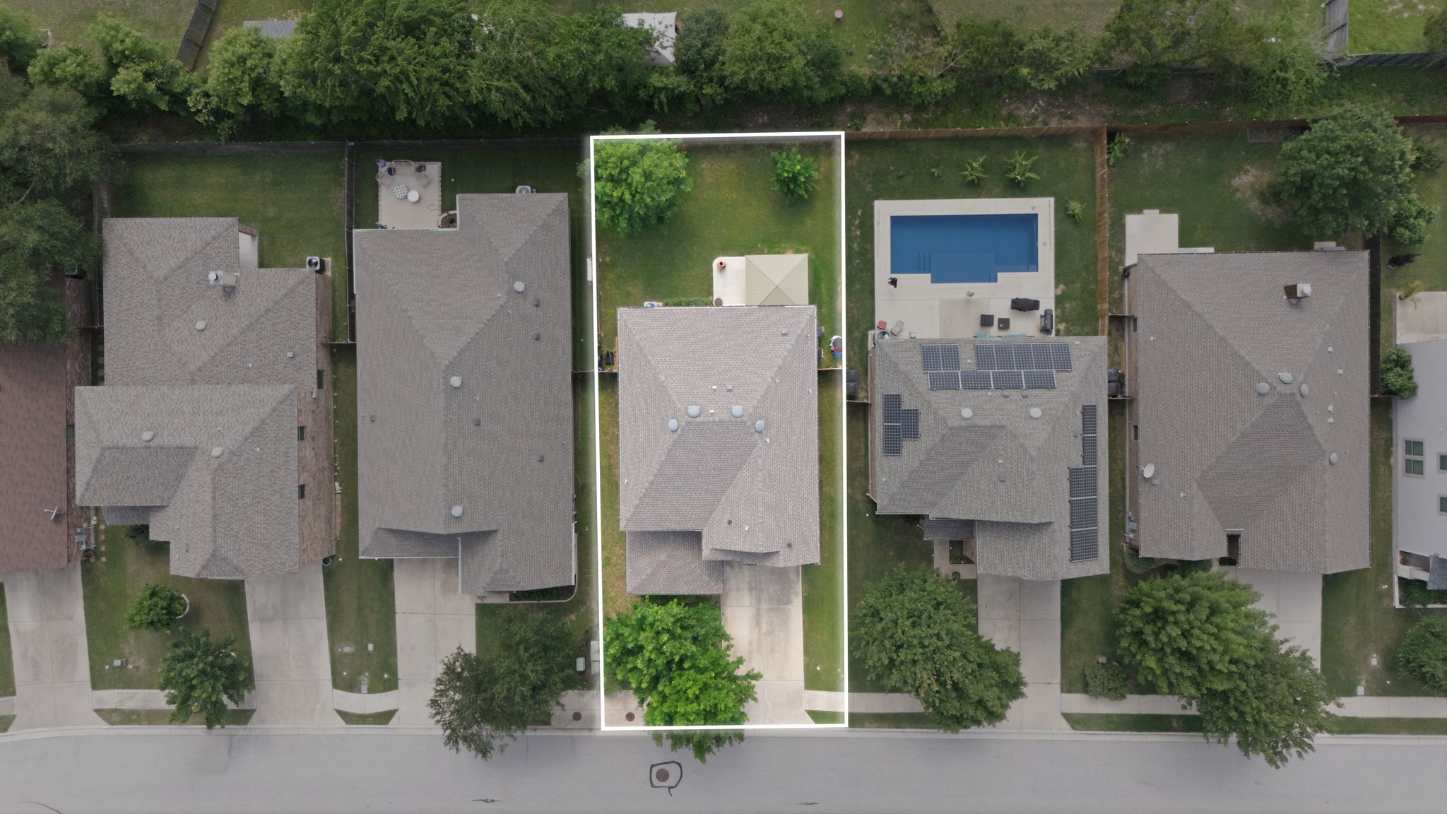 1133 Yellow Iris Road Leander, TX 78641 - Photo 34 of 37 Aerial perspective showcasing a residential property with a gray-shingled roof and an established front yard tree
