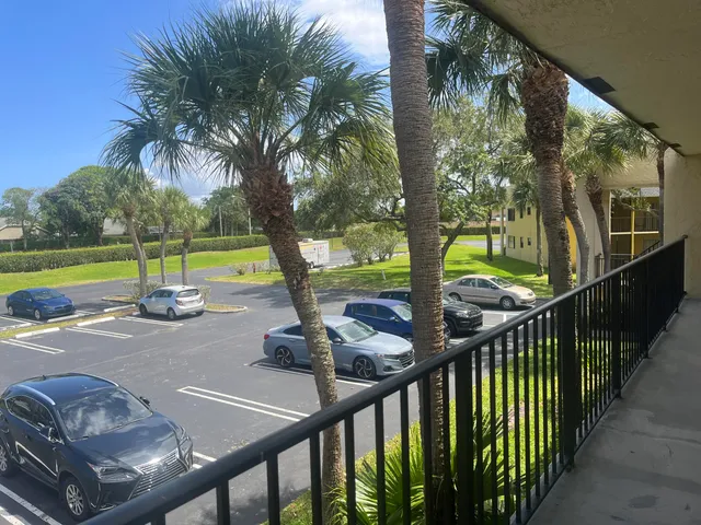 a view of a porch with furniture and a yard