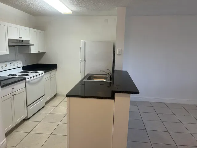 a kitchen with cabinets and appliances