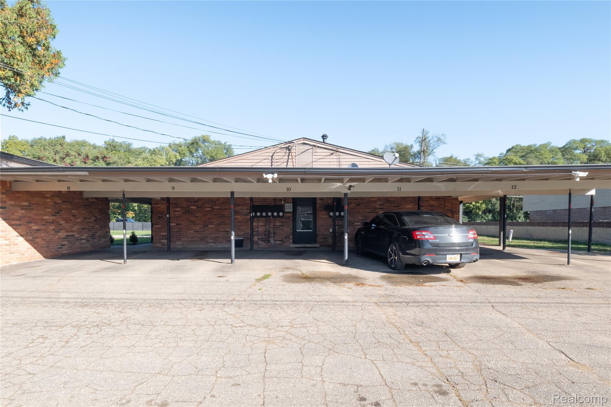 3065 South Commerce Road, Unit 9 Walled Lake, MI 48390 - Photo 15 of 15 Brick exterior, covered parking, and multiple units