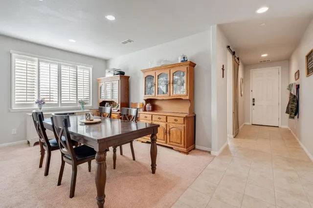 a view of a a dining room with furniture and window