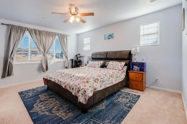 a bedroom with a large bed and a window