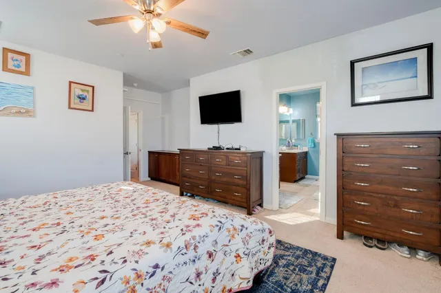 a bedroom with a bed and a television