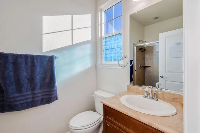 a bathroom with a toilet a sink and a mirror