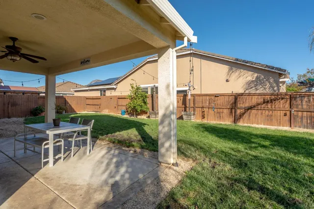 a view of backyard with outdoor seating and plants