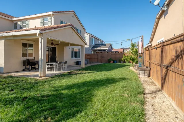 a view of a house with a yard and porch