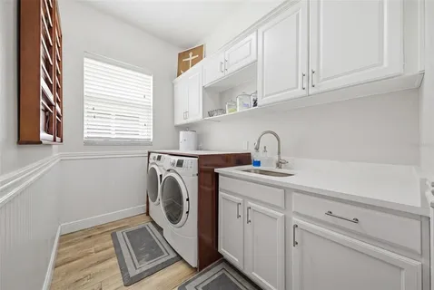 a utility room with sink dryer and washer