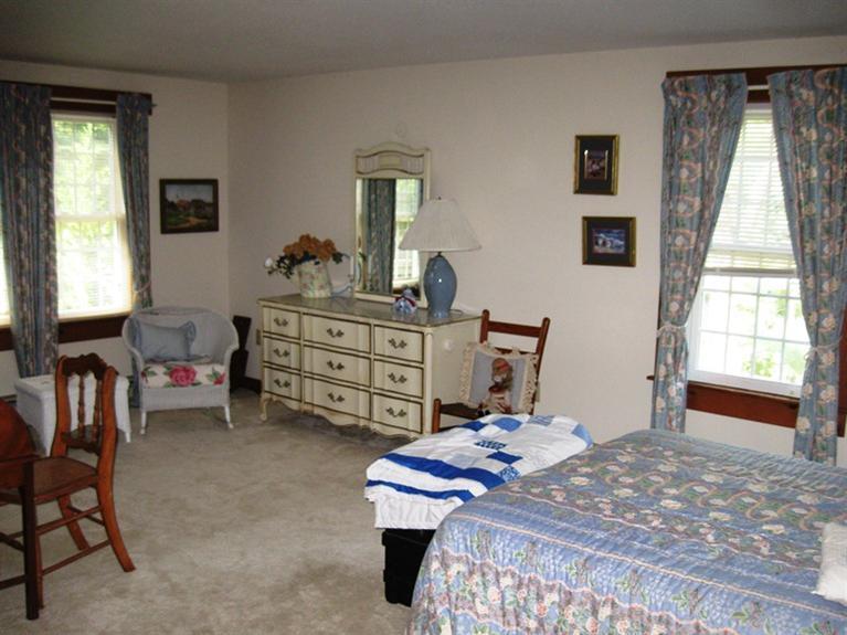 1250 Samoset Road Eastham, MA 02642 - Photo 23 of 29 a bedroom with a bed and a dresser next to a window