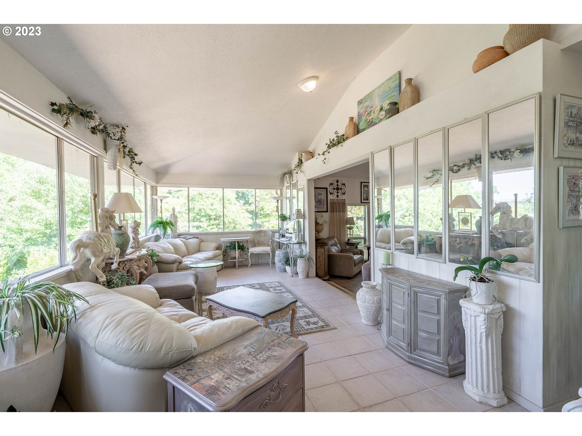 12750 Clow Corner Road Dallas, OR 97338 - Photo 13 of 43 a living room with furniture large windows and a fireplace