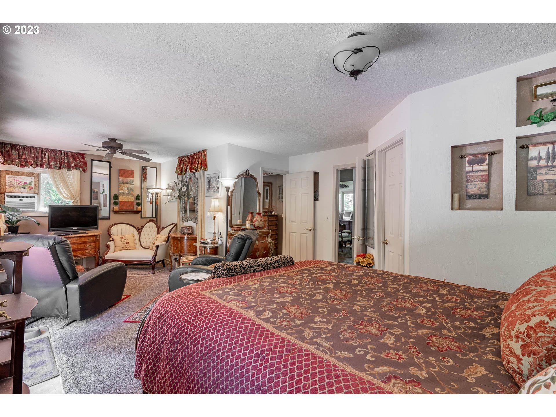12750 Clow Corner Road Dallas, OR 97338 - Photo 25 of 43 a bedroom with furniture and a flat screen tv