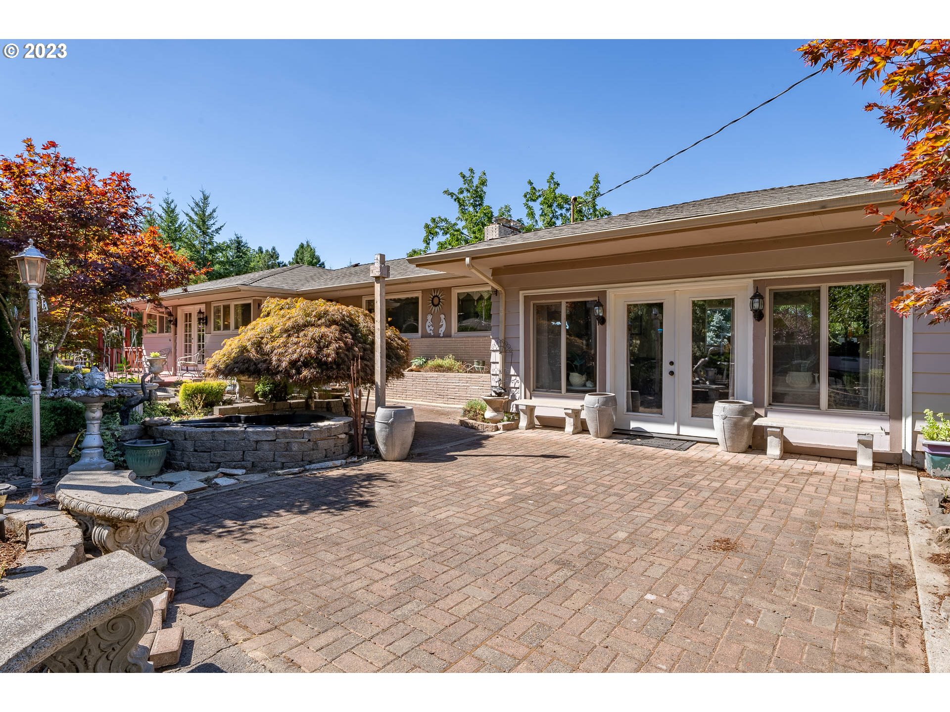 12750 Clow Corner Road Dallas, OR 97338 - Photo 4 of 43 a view of a patio with table and chairs potted plants and floor to ceiling window