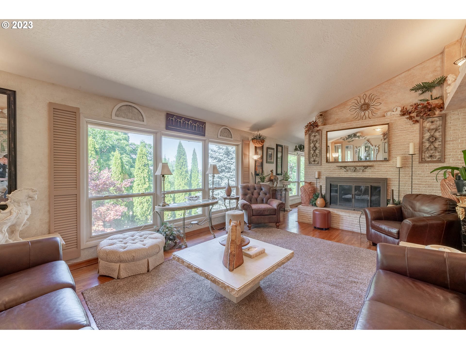 12750 Clow Corner Road Dallas, OR 97338 - Photo 9 of 43 a living room with furniture a fireplace and large windows