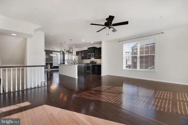 a view of a living room and kitchen with a large window