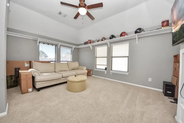 a bedroom with a bed a mirror and window