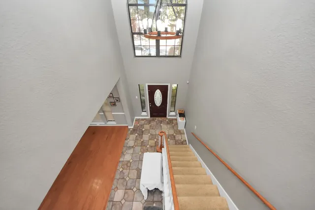 a view of a hallway with wooden floor and a large window