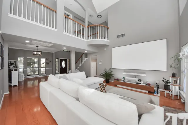 a living room with furniture and wooden floor