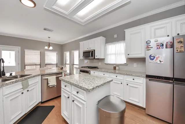 a kitchen with a sink stove and refrigerator