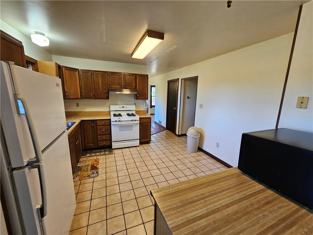 1015 McElree Road Washington, PA 15301 - Photo 23 of 48 a kitchen with a refrigerator and a stove top oven