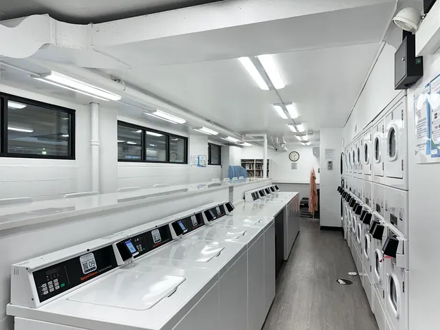 a large white kitchen with stainless steel appliances