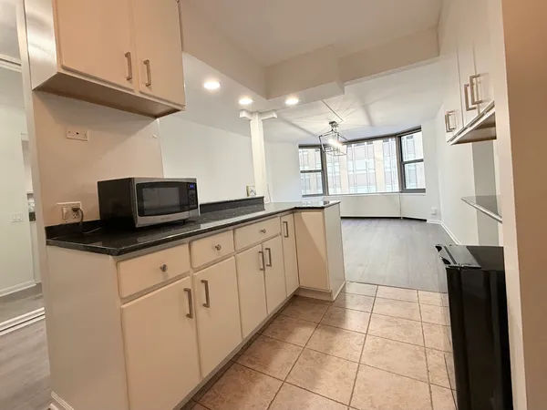 a kitchen with stainless steel appliances granite countertop a sink and a stove