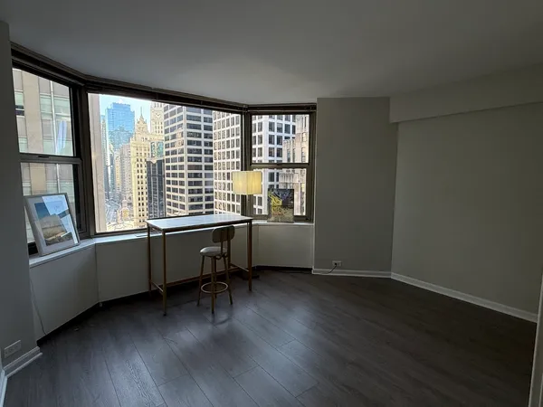 a room with a window and wooden floor