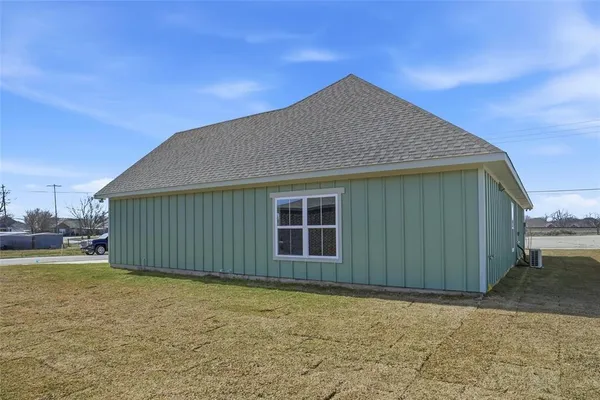 a house with a yard space and wooden fence