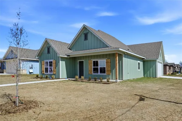 a front view of a house with basket ball court and a garage