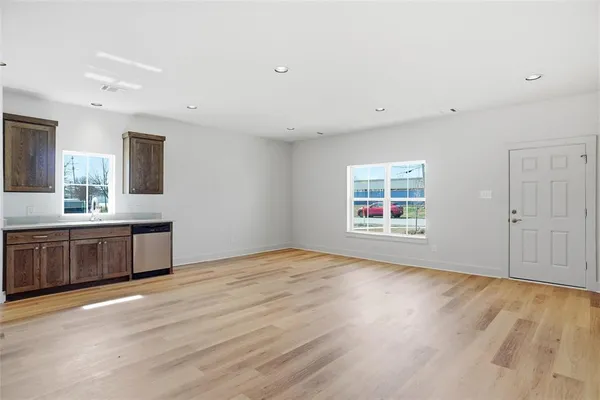 a view of kitchen with granite countertop cabinets and window
