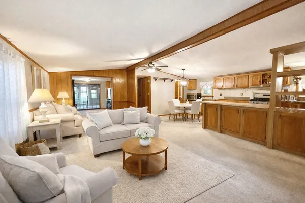 a living room with furniture and a chandelier