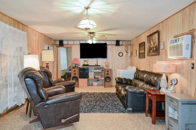 a living room with furniture and a chandelier