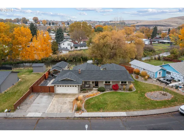 an aerial view of residential houses with outdoor space