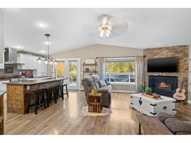 a living room with fireplace furniture and a flat screen tv