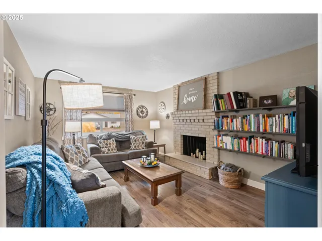 a living room with furniture a fireplace and a book shelf