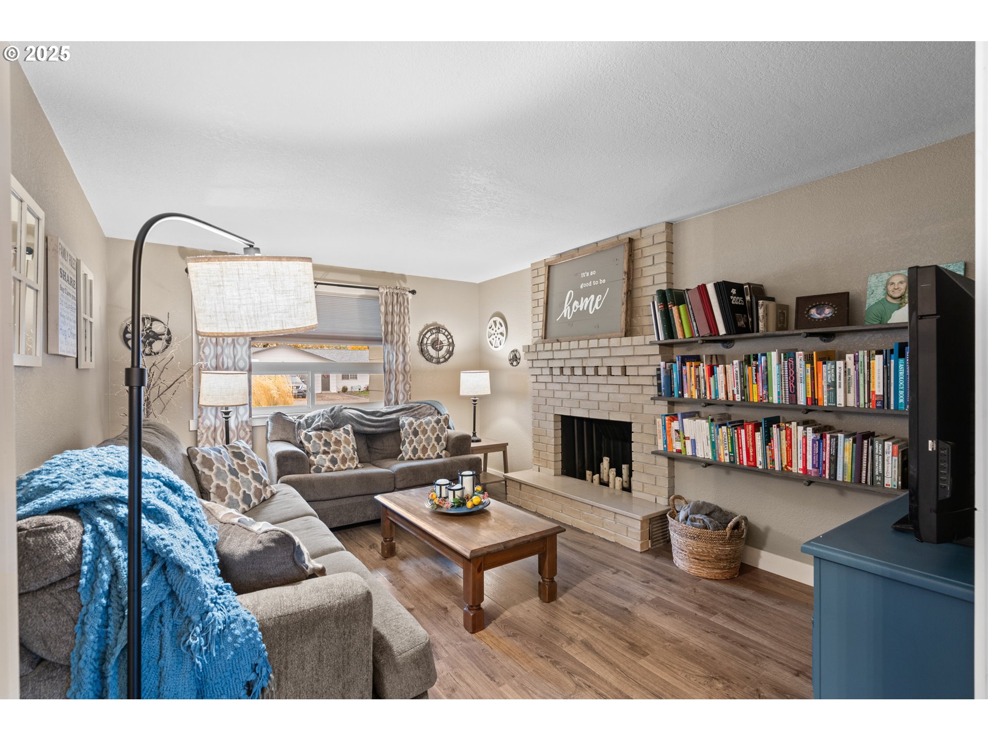 1328 Southwest 44th Street Pendleton, OR 97801 - Photo 16 of 43 a living room with furniture a fireplace and a book shelf