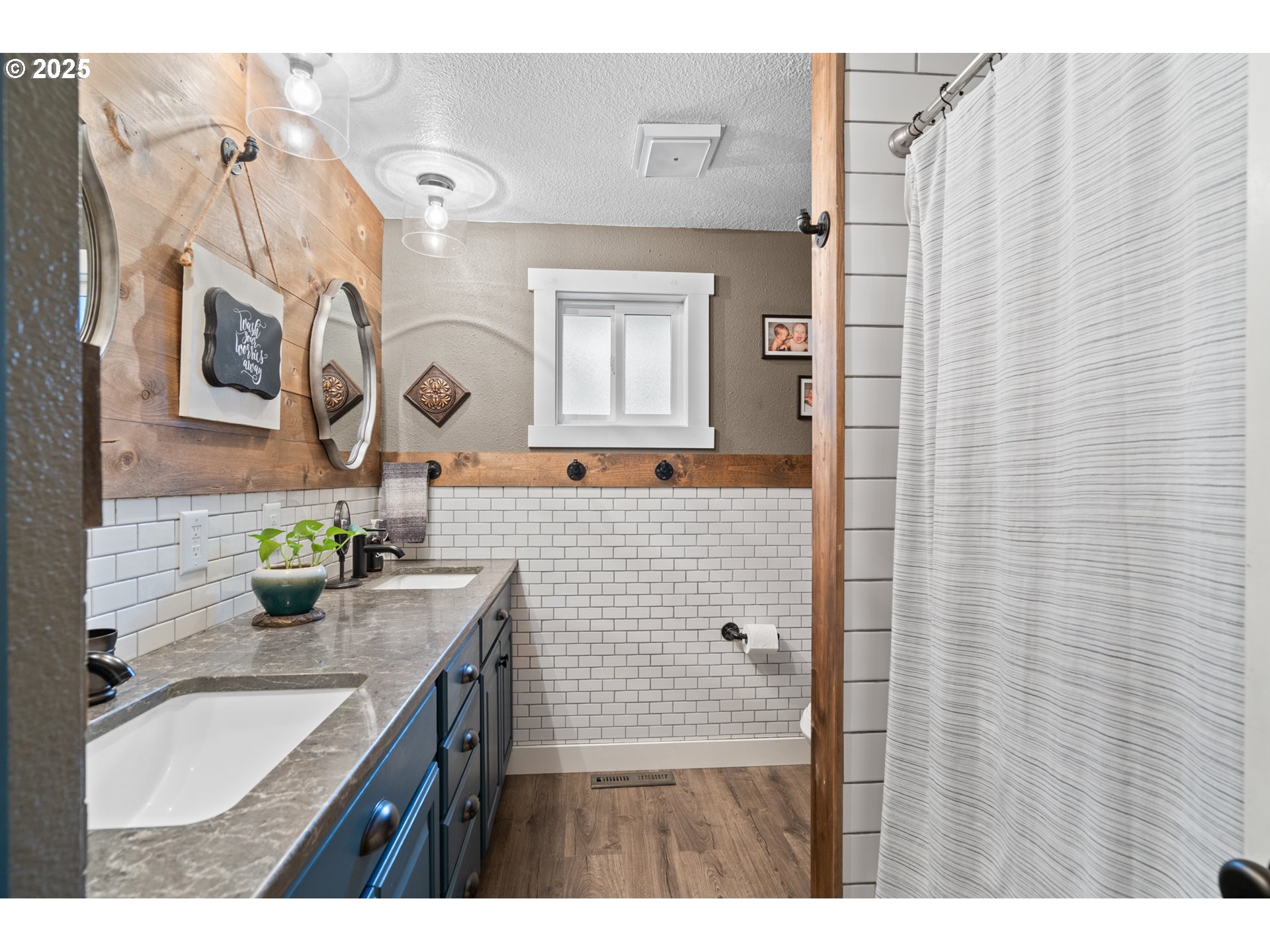 1328 Southwest 44th Street Pendleton, OR 97801 - Photo 20 of 43 a bathroom with a granite countertop sink a mirror a vanity and shower curtain