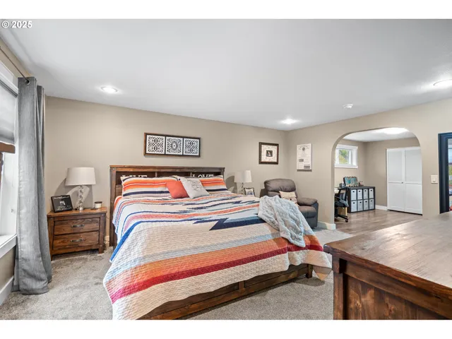 a bedroom with furniture and a wooden floor