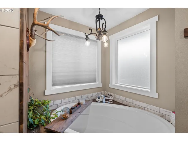a bathroom with a granite countertop sink mirror and a shower