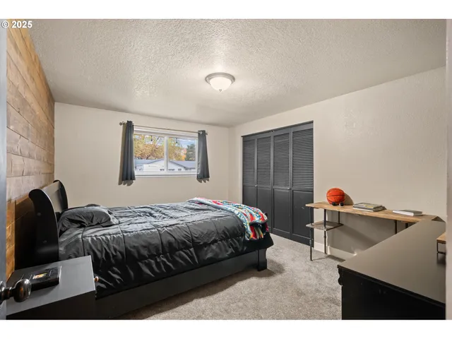 a bedroom with a bed and a dresser