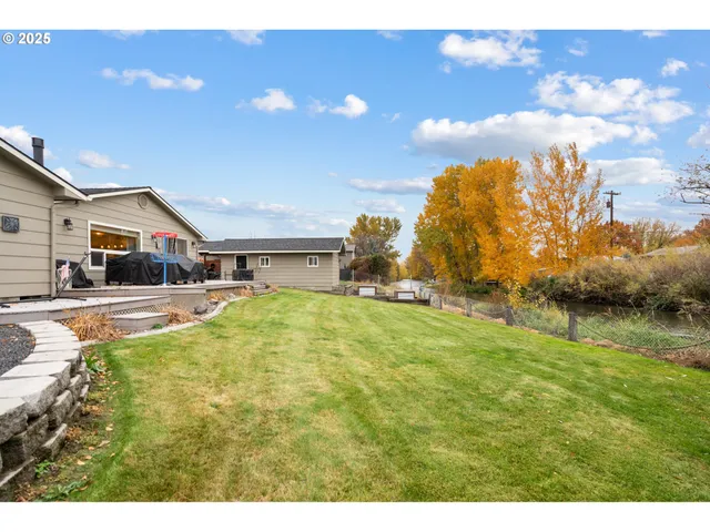 a swimming pool with trees in the background