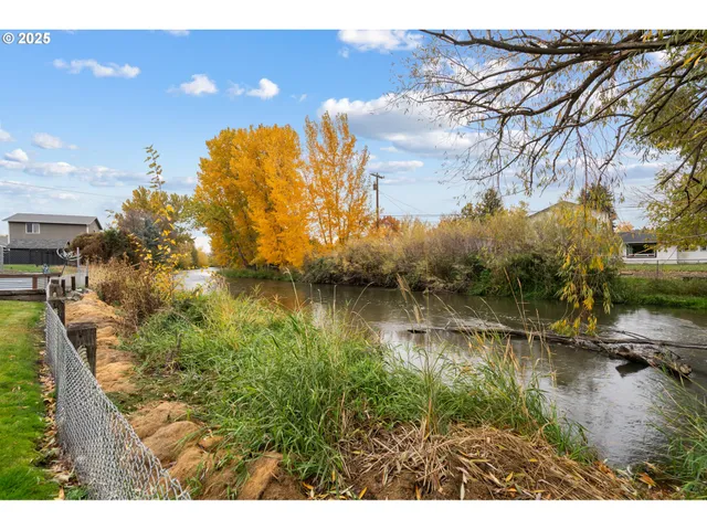 a view of residential houses with outdoor space and lake view