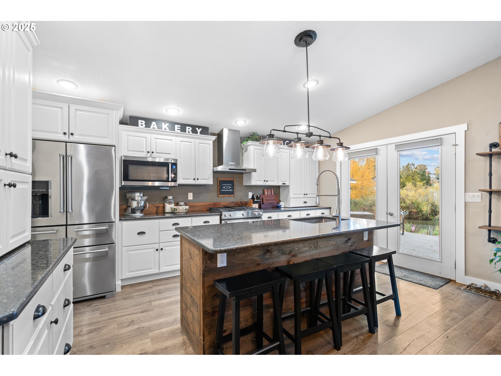 1328 Southwest 44th Street Pendleton, OR 97801 - Photo 5 of 43 a kitchen with kitchen island a counter space a refrigerator and cabinets