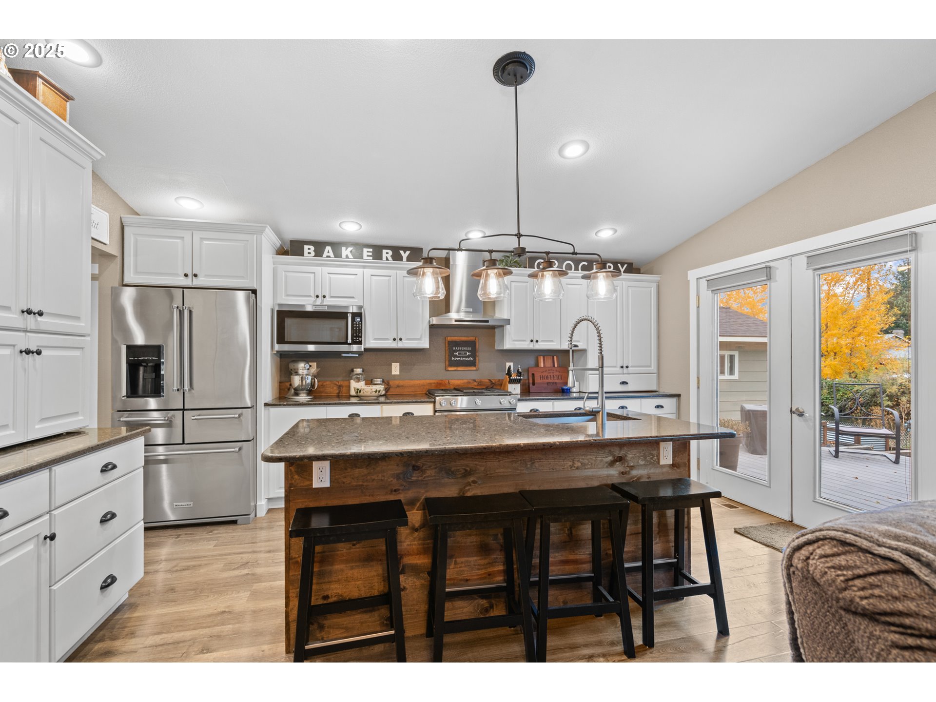1328 Southwest 44th Street Pendleton, OR 97801 - Photo 8 of 43 a kitchen with stainless steel appliances kitchen island granite countertop a table chairs sink and cabinets