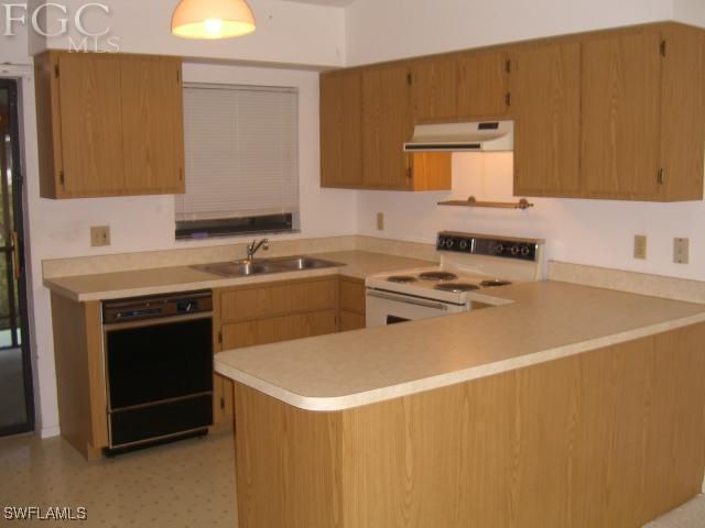 18221 Matanzas Road Fort Myers, FL 33967 - Photo 3 of 10 a kitchen with a sink a stove and cabinets