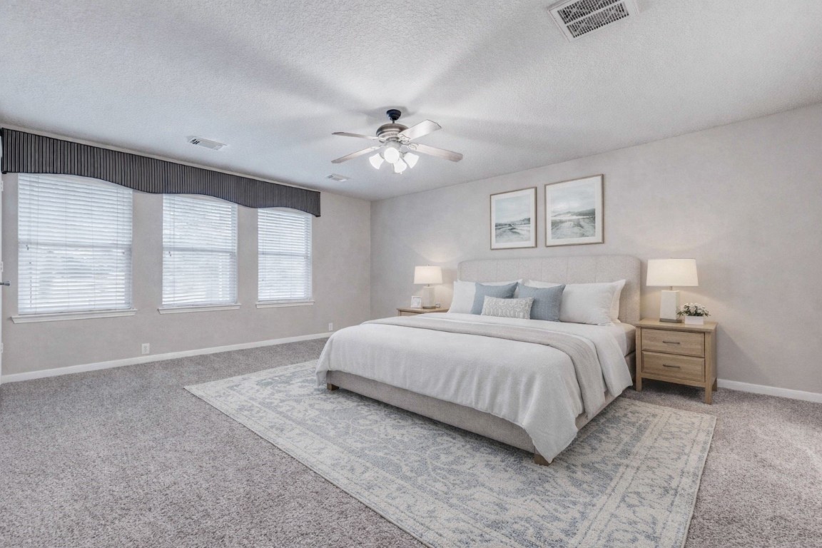 18327 Atasca Wds Trace Humble, TX 77346 - Photo 14 of 28 a spacious bedroom with a large bed and a chandelier