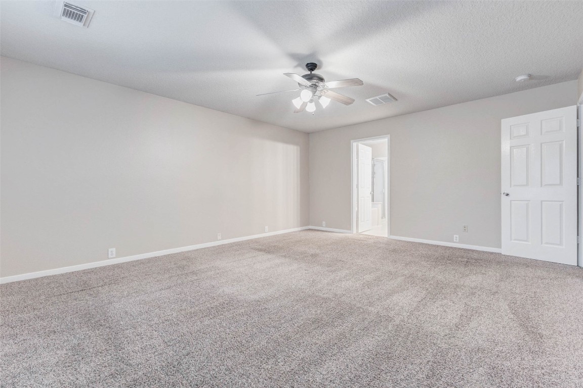 18327 Atasca Wds Trace Humble, TX 77346 - Photo 15 of 28 a view of an empty room with a chandelier fan