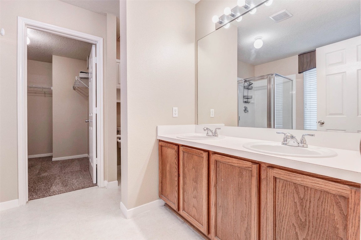 18327 Atasca Wds Trace Humble, TX 77346 - Photo 16 of 28 a bathroom with a double vanity sink mirror and double